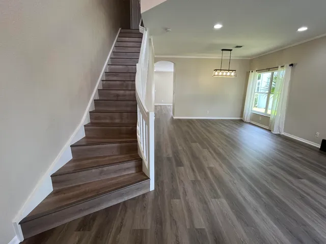 a view of entryway and hall with wooden floor