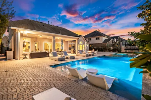 a view of a patio with swimming pool table and chairs