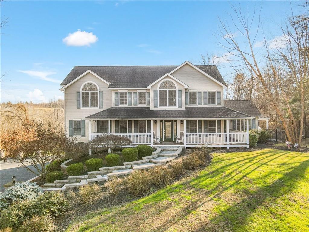 View of front of home featuring a front yard and a porch