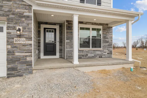 front view of a brick house with a large window