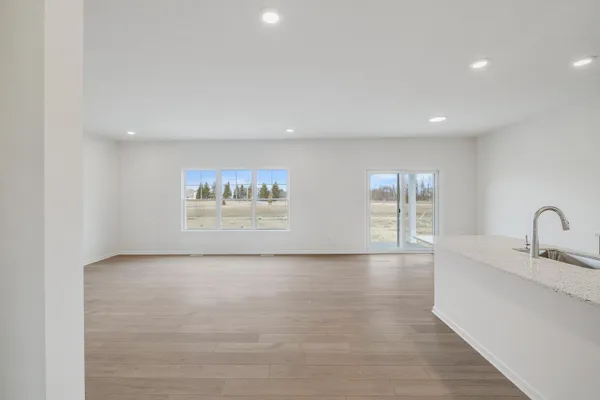 a view of kitchen with stainless steel appliances granite countertop a sink and a large window