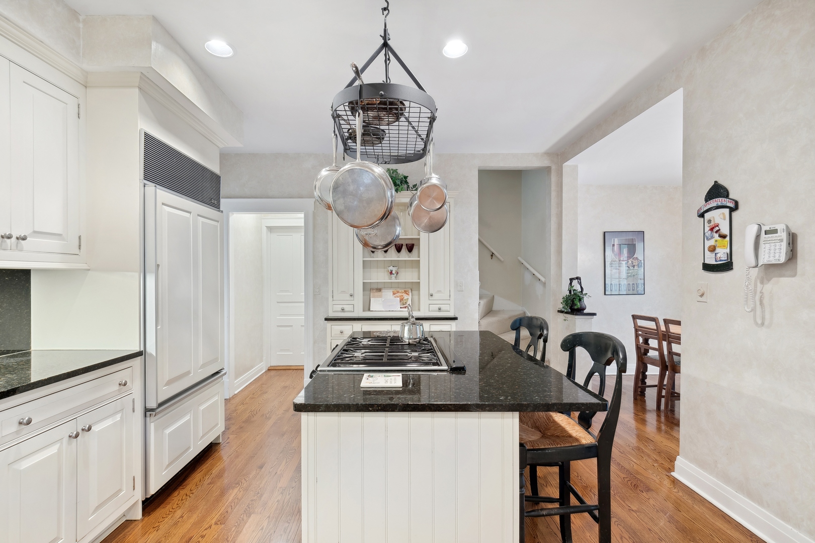 451 North Green Bay Road Lake Forest, IL 60045 - Photo 7 of 24 a kitchen with stainless steel appliances granite countertop a stove white cabinets a dining table and chairs