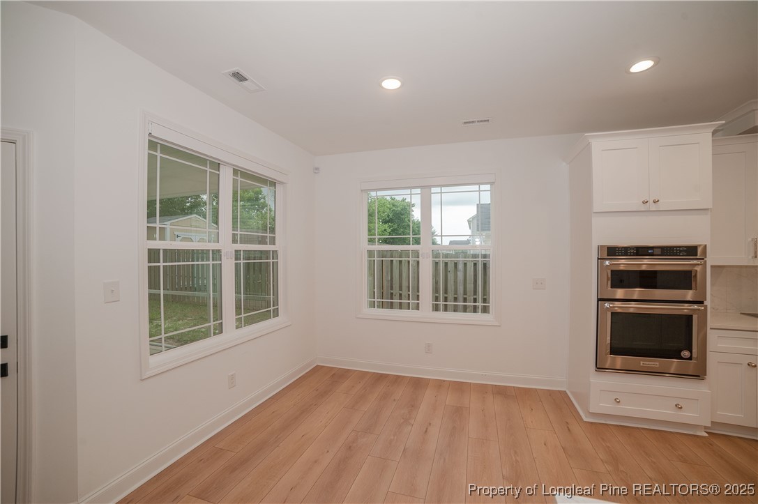 212 Stafford Avenue Raeford, NC 28376 - Photo 12 of 41 a view of an empty room with a window and wooden floor