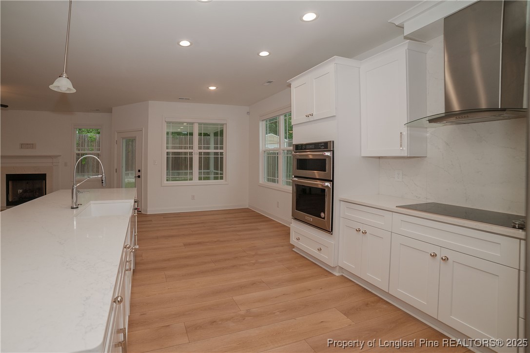 212 Stafford Avenue Raeford, NC 28376 - Photo 17 of 41 a kitchen with stainless steel appliances a stove top oven a sink a refrigerator and cabinets