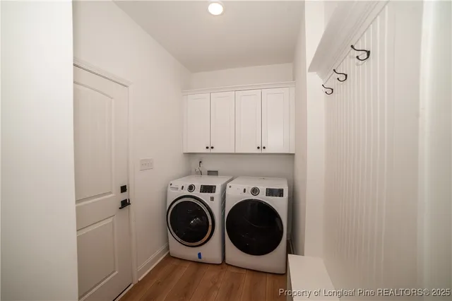a utility room with sink dryer and washer