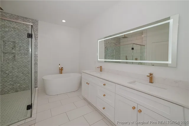 a bathroom with a bathtub sink and mirror