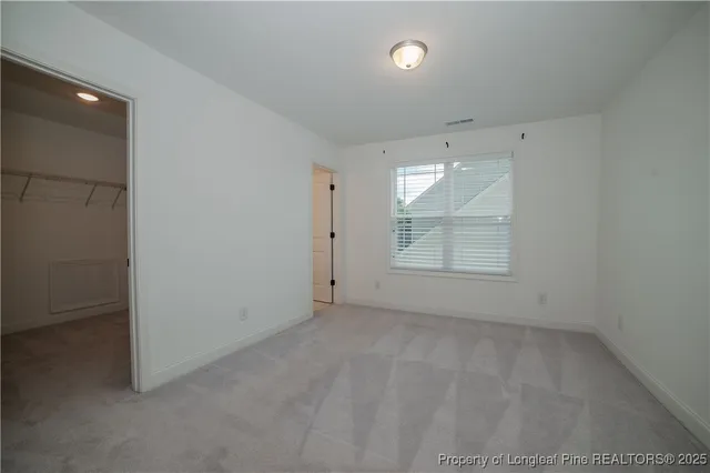 an empty room with a window and natural light
