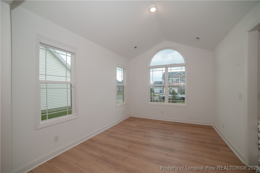 212 Stafford Avenue Raeford, NC 28376 - Photo 3 of 41 an empty room with wooden floor and windows
