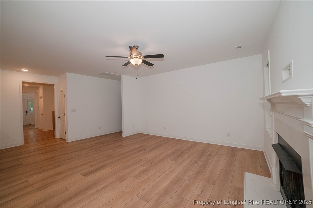 212 Stafford Avenue Raeford, NC 28376 - Photo 8 of 41 a view of an empty room with wooden floor and a fireplace