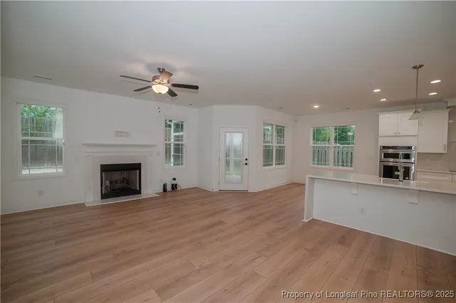 a view of an empty room with a fireplace and a window
