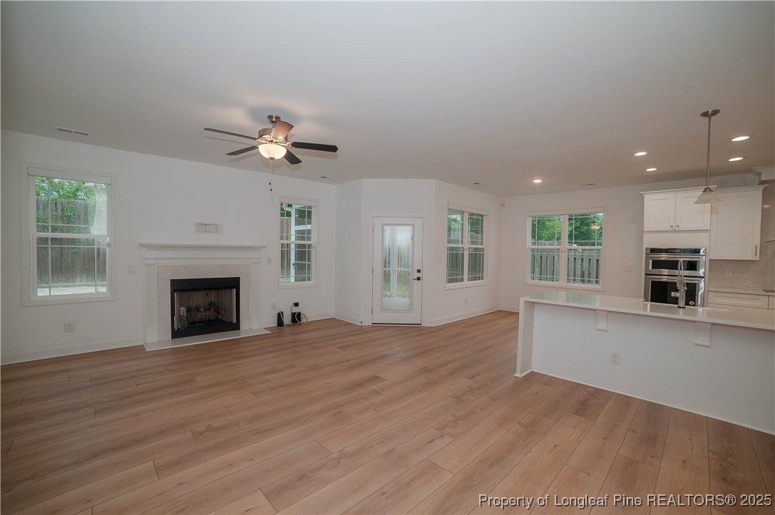 212 Stafford Avenue Raeford, NC 28376 - Photo 10 of 41 a view of an empty room with a fireplace and a window