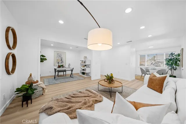 a living room with furniture and a mirror