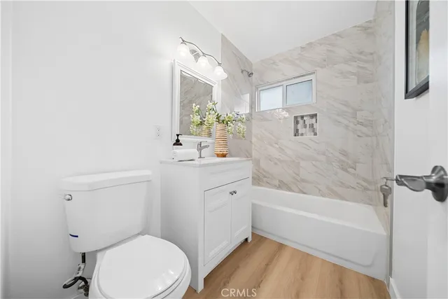 a bathroom with a sink mirror vanity and toilet