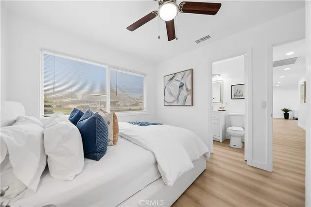 a bedroom with a large bed and a window