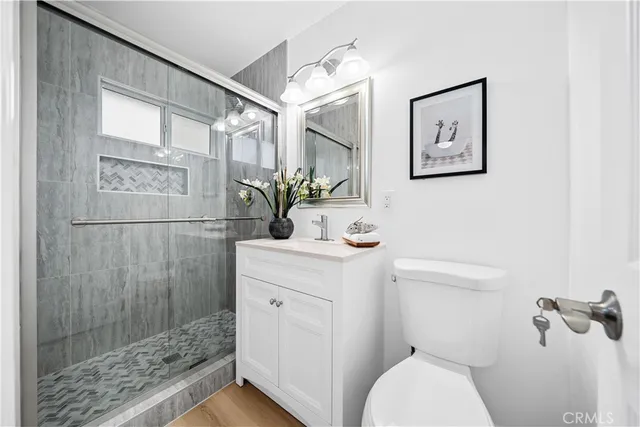a bathroom with a sink mirror and a shower
