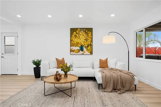 a living room with furniture and wooden floor
