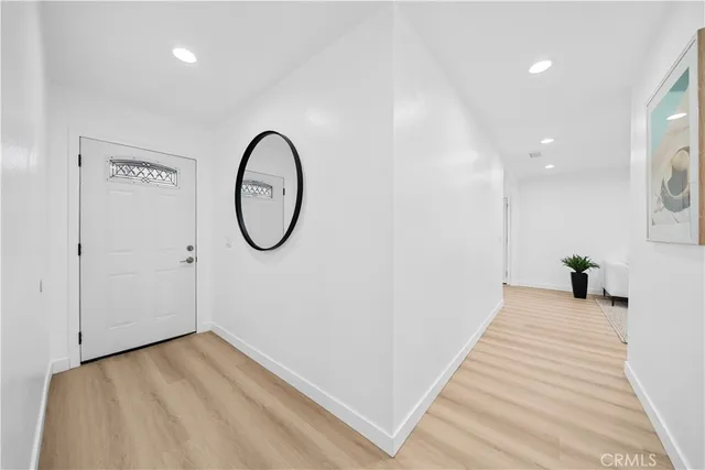 a view of a room with wooden floor and a ceiling fan