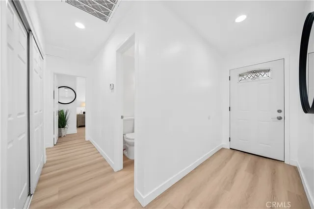 a view of a hallway with wooden floor