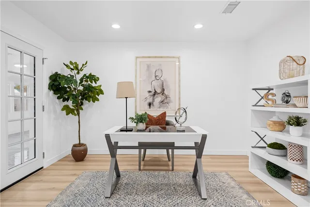 a living room with furniture potted plant and a lamp