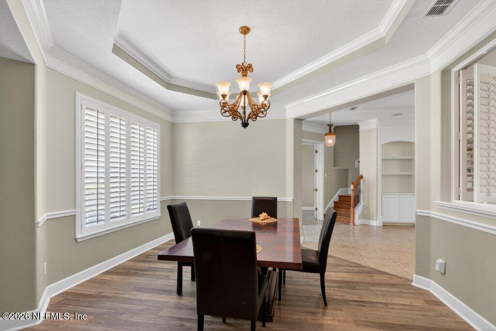 1664 Fairway Ridge Drive Fleming Island, FL 32003 - Photo 13 of 103 a view of a dining room with furniture and a chandelier