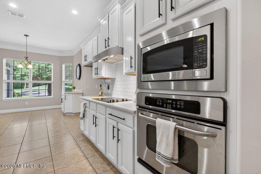 1664 Fairway Ridge Drive Fleming Island, FL 32003 - Photo 20 of 103 a kitchen with stainless steel appliances white cabinets and stove