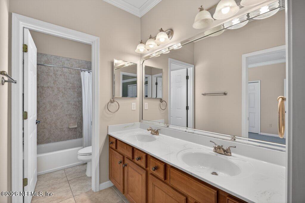 1664 Fairway Ridge Drive Fleming Island, FL 32003 - Photo 64 of 103 a spacious bathroom with a granite countertop sink a toilet and a large mirror