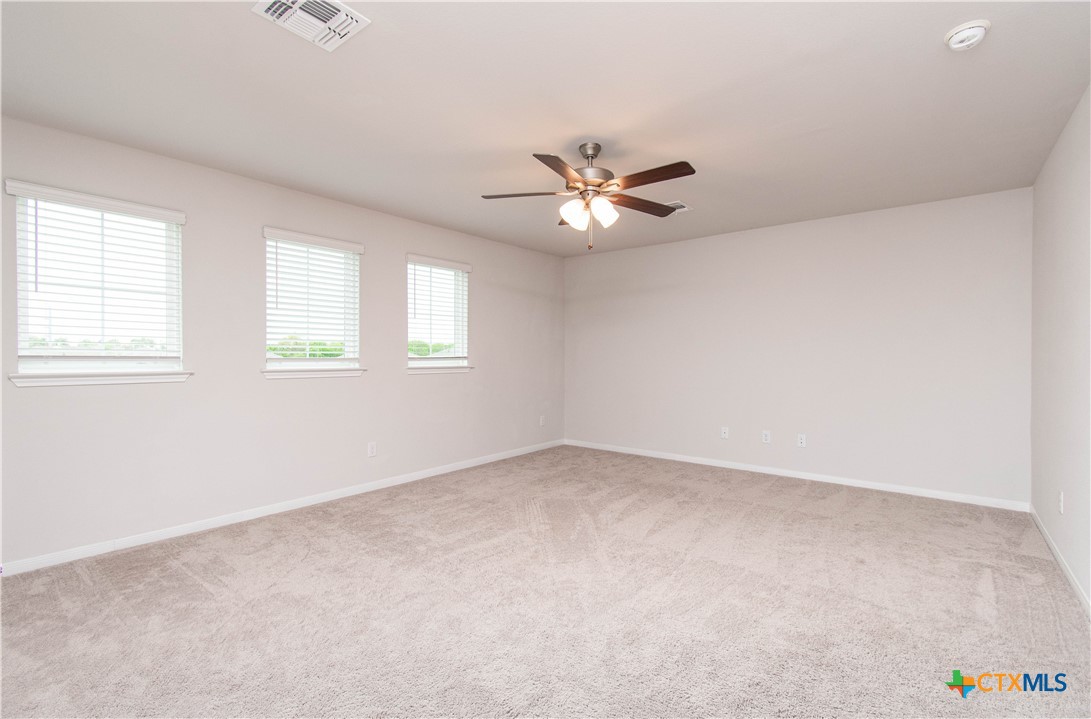736 Jersey Court Troy, TX 76579 - Photo 17 of 32 an empty room with windows and ceiling fan