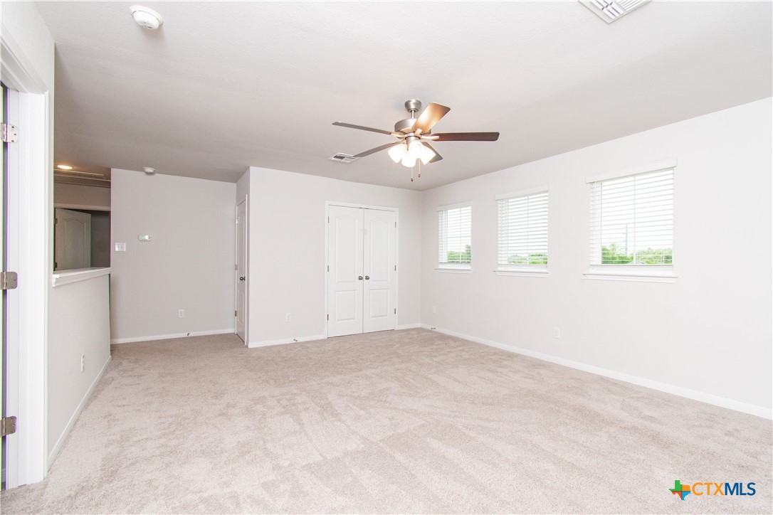 736 Jersey Court Troy, TX 76579 - Photo 19 of 32 an empty room with windows and chandelier fan