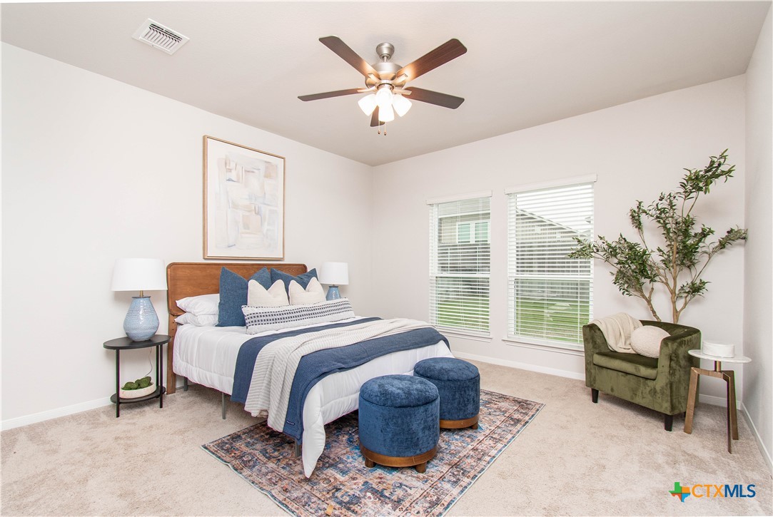 736 Jersey Court Troy, TX 76579 - Photo 3 of 32 a bedroom with a large bed and a chandelier