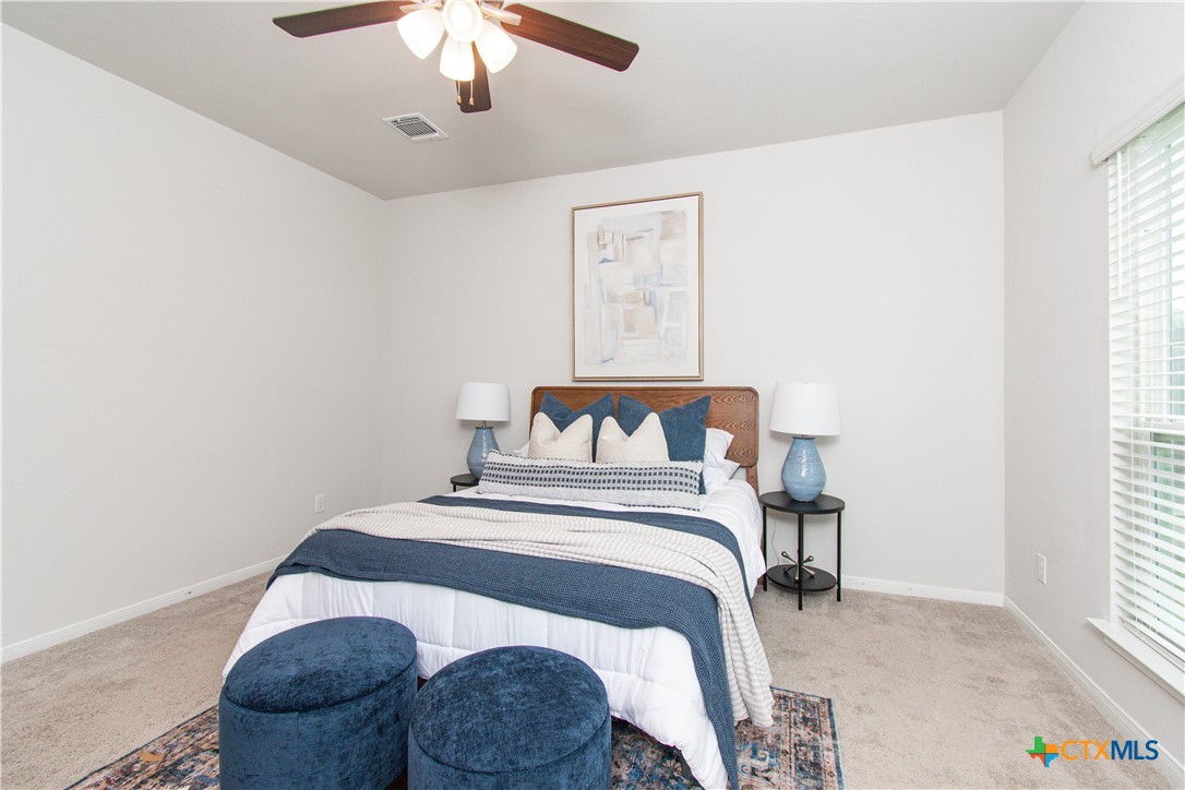 736 Jersey Court Troy, TX 76579 - Photo 9 of 32 a bedroom with a bed and chandelier