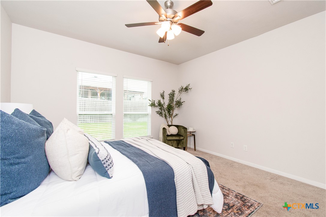 736 Jersey Court Troy, TX 76579 - Photo 10 of 32 a bedroom with a large bed and a chandelier