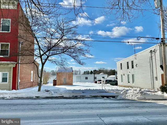 a view of a building with snow on the road