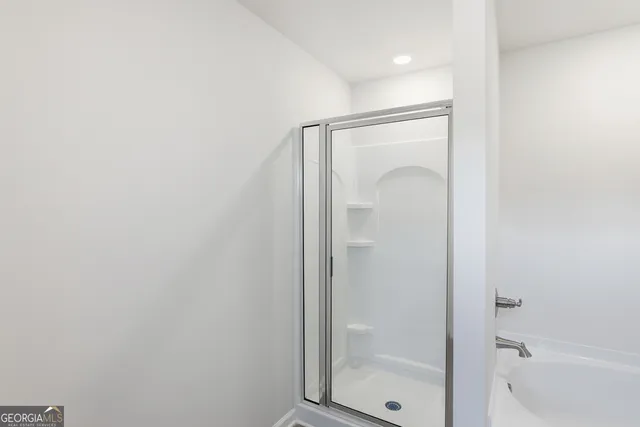 a bathroom with a glass shower door