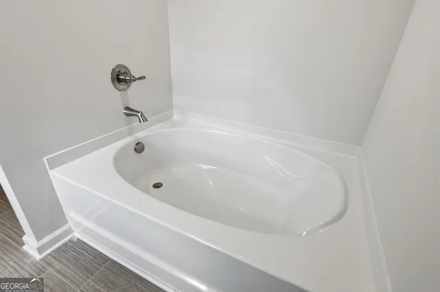 a white bath tub sitting in a bathroom