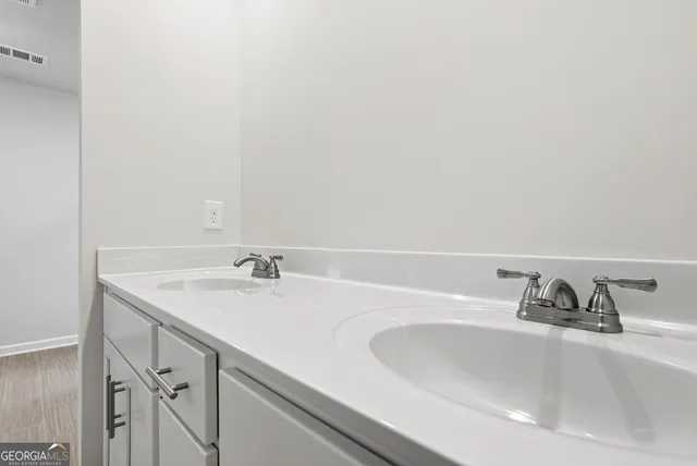 a bathroom with a sink and a window