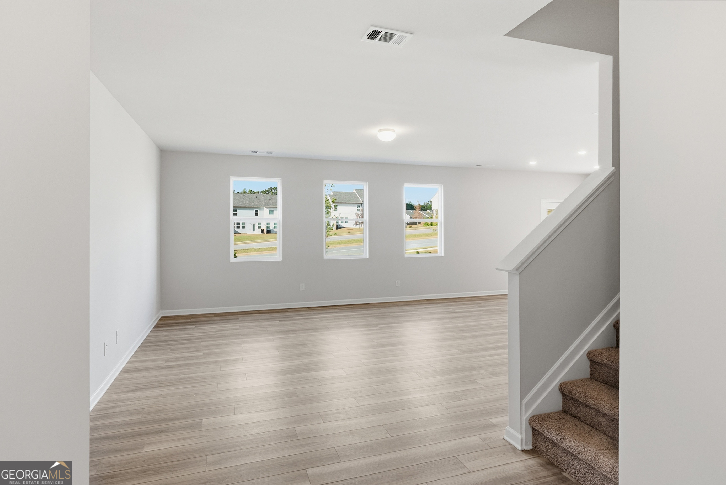 30 Umber Lane Newnan, GA 30263 - Photo 3 of 33 a view of an empty room with wooden floor and a window