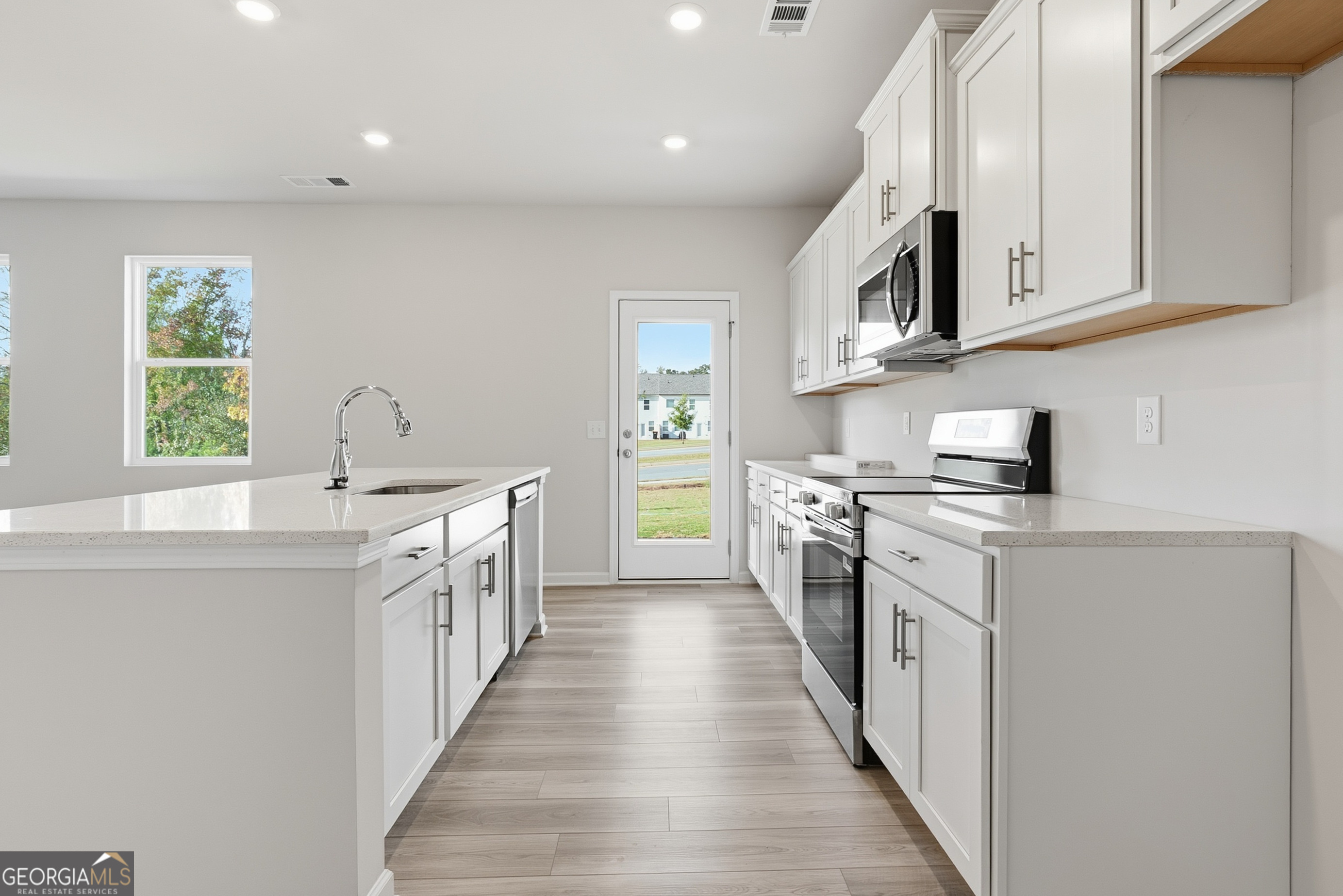 30 Umber Lane Newnan, GA 30263 - Photo 7 of 33 a kitchen with stainless steel appliances granite countertop a stove a sink and a refrigerator