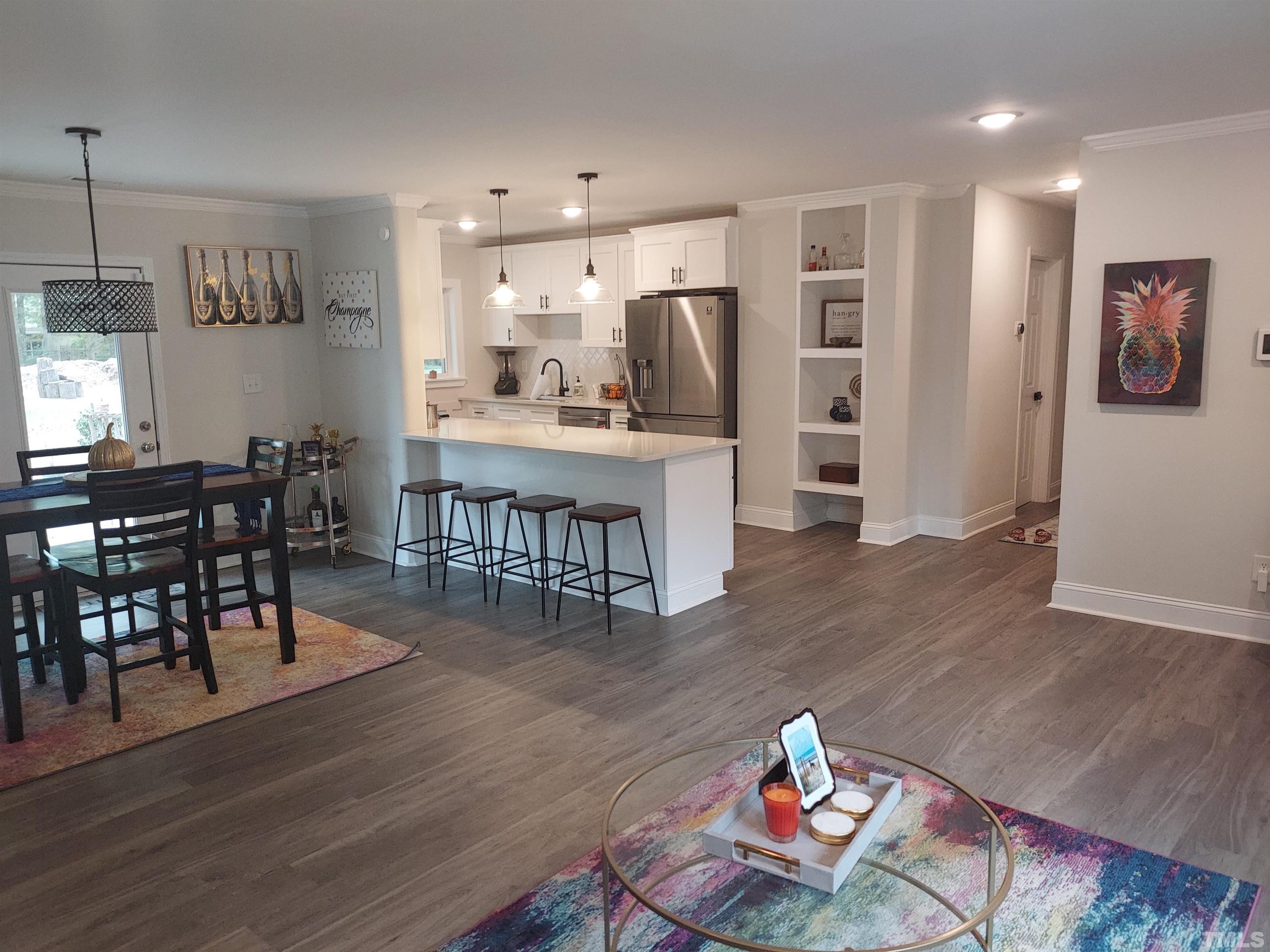 3811 Pickett Road Durham, NC 27705 - Photo 2 of 22 a living room with furniture and wooden floor
