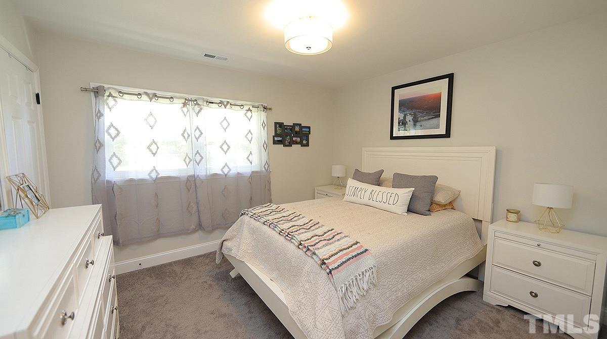 3811 Pickett Road Durham, NC 27705 - Photo 14 of 22 a bedroom with a bed and a window