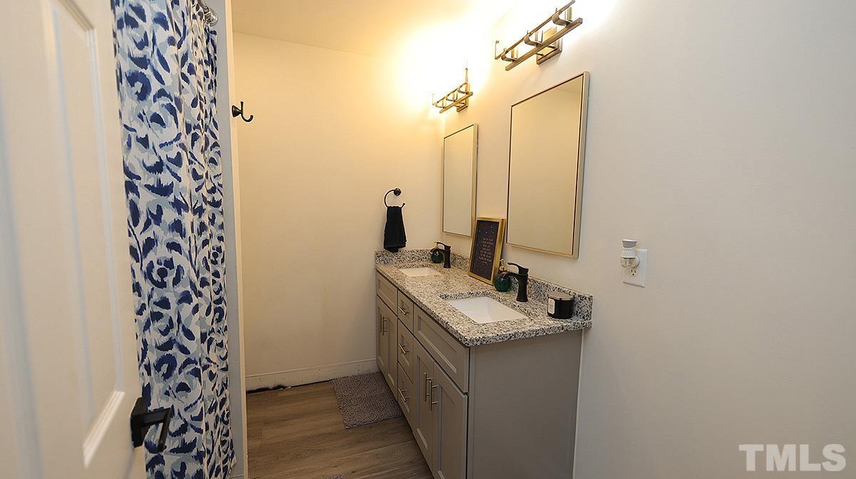 3811 Pickett Road Durham, NC 27705 - Photo 16 of 22 a bathroom with a sink and a mirror