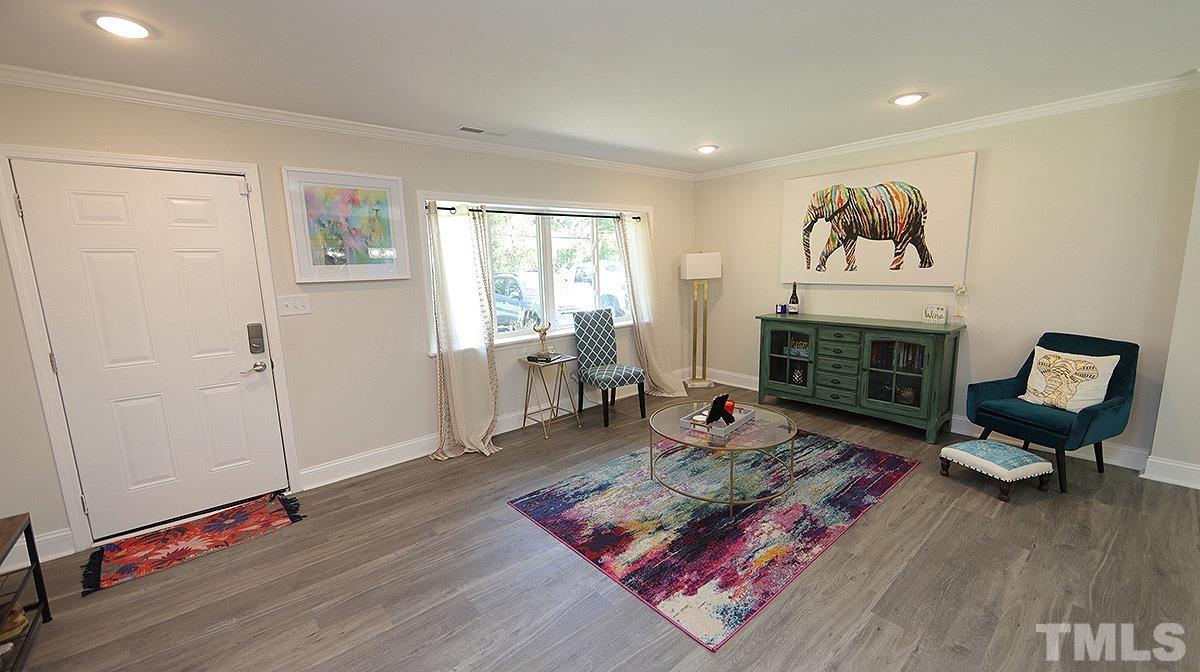 3811 Pickett Road Durham, NC 27705 - Photo 4 of 22 a living room with furniture fireplace and wooden floor