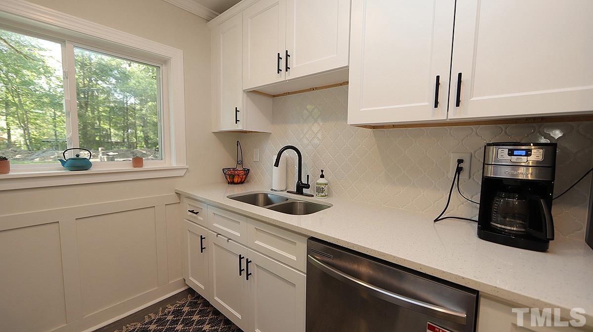 3811 Pickett Road Durham, NC 27705 - Photo 6 of 22 a kitchen with stainless steel appliances a sink stove and cabinets