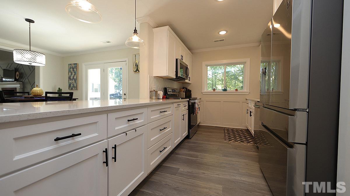 3811 Pickett Road Durham, NC 27705 - Photo 8 of 22 a large white kitchen with a window