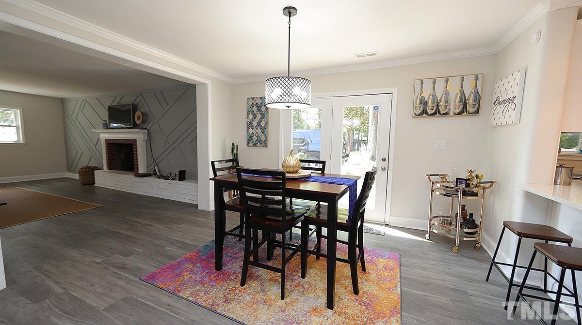3811 Pickett Road Durham, NC 27705 - Photo 9 of 22 a view of a dining room with furniture window and wooden floor