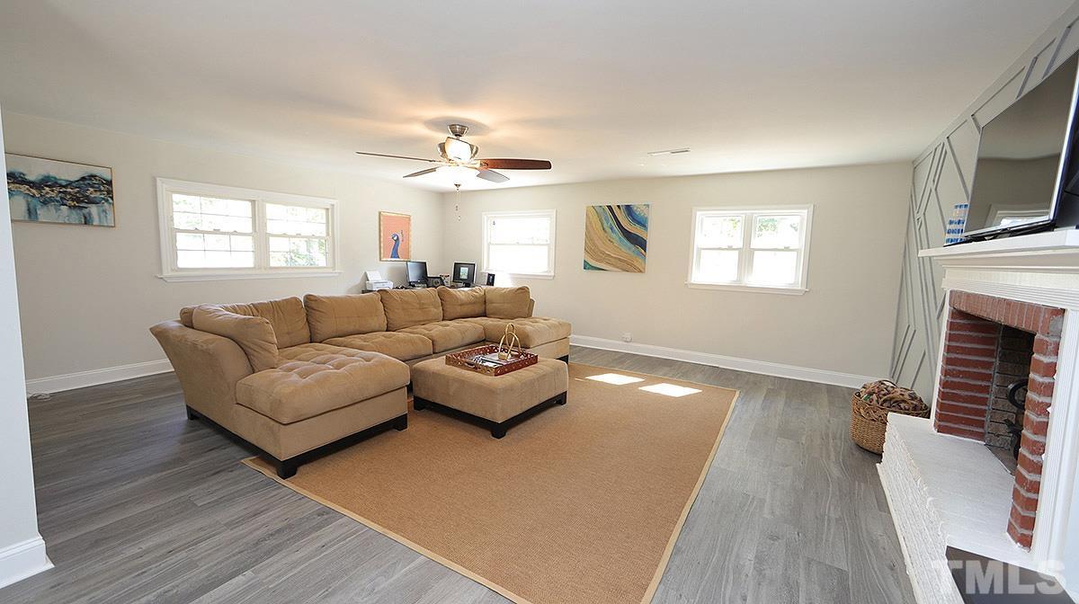 3811 Pickett Road Durham, NC 27705 - Photo 10 of 22 a living room with furniture and a fireplace