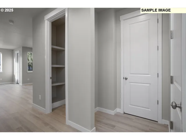 a view of hallway with wooden floor