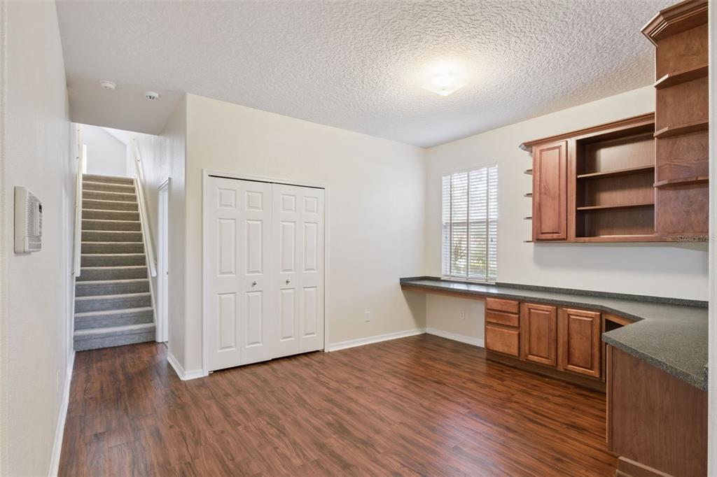 597 Sand Wedge Loop Apopka, FL 32712 - Photo 17 of 40 a kitchen with stainless steel appliances granite countertop a dishwasher a stove and a wooden floors