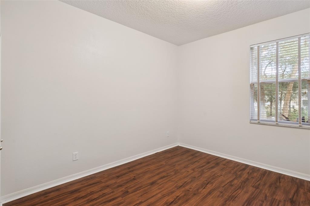 597 Sand Wedge Loop Apopka, FL 32712 - Photo 24 of 40 a view of an empty room with wooden floor and a window
