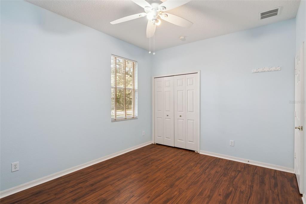 597 Sand Wedge Loop Apopka, FL 32712 - Photo 25 of 40 a view of an empty room with wooden floor and a window