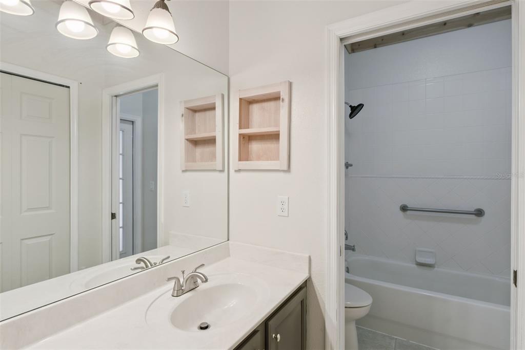 597 Sand Wedge Loop Apopka, FL 32712 - Photo 30 of 40 a bathroom with a bathtub shower sink vanity and a toilet